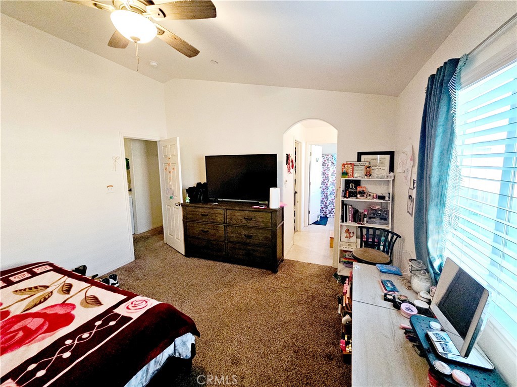 301 Moonstone Beach Court Delano, CA 93215 - Photo 18 of 31 a bedroom with furniture and a flat screen tv