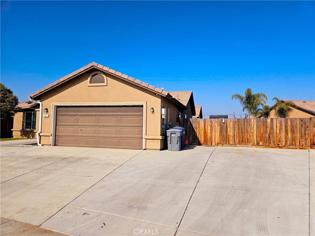 301 Moonstone Beach Court Delano, CA 93215 - Photo 2 of 31 a view of a house with a garage