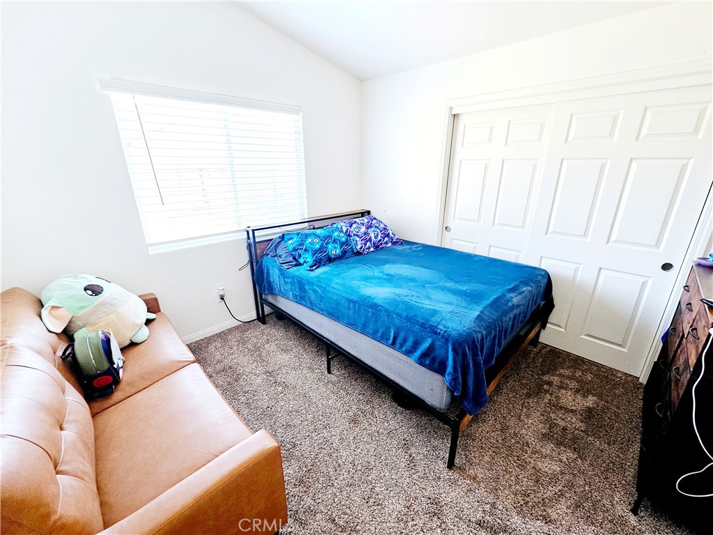 301 Moonstone Beach Court Delano, CA 93215 - Photo 22 of 31 a bed sitting in a bedroom next to a window