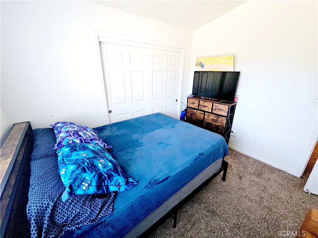 301 Moonstone Beach Court Delano, CA 93215 - Photo 23 of 31 a bedroom with a bed and a window