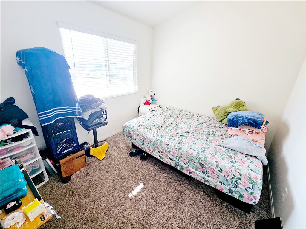 301 Moonstone Beach Court Delano, CA 93215 - Photo 24 of 31 a bedroom with a bed and wooden floor