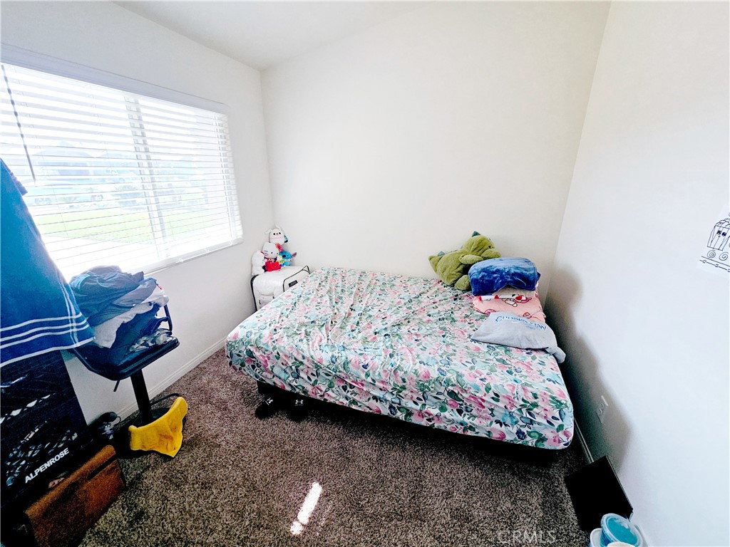 301 Moonstone Beach Court Delano, CA 93215 - Photo 25 of 31 a bedroom with a bed and a window
