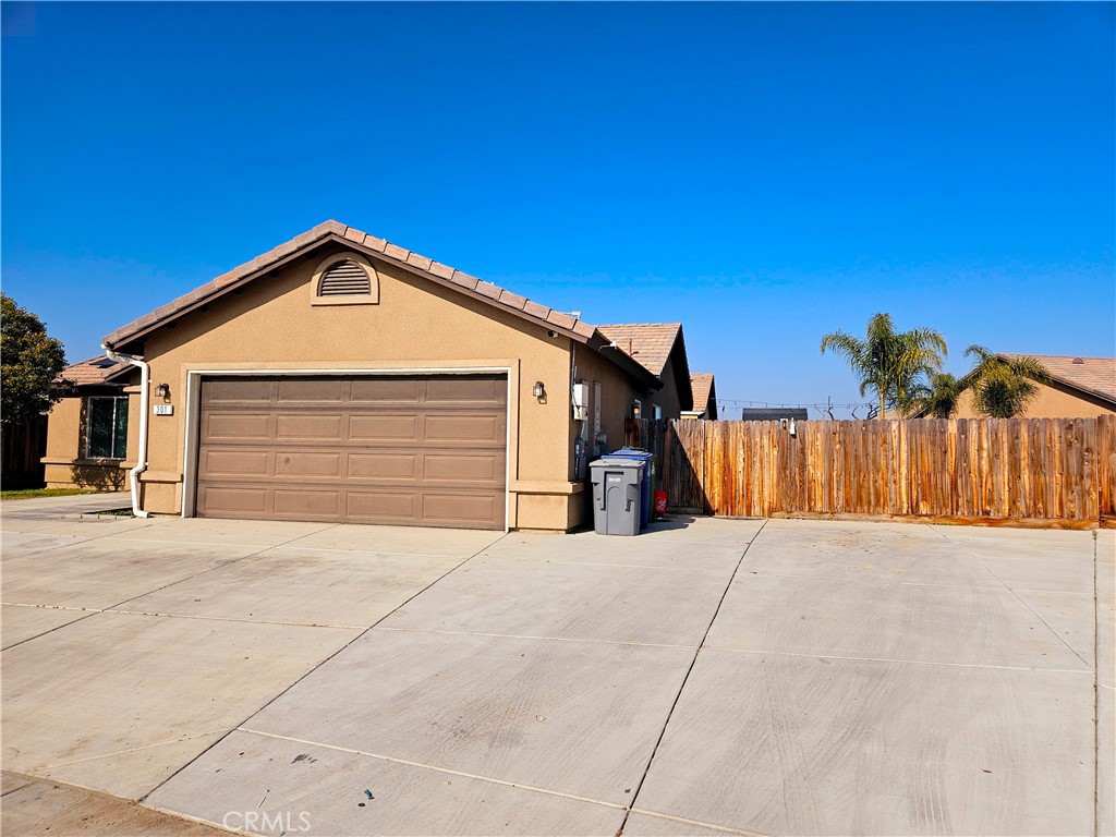 301 Moonstone Beach Court Delano, CA 93215 - Photo 3 of 31 a view of a house with a garage