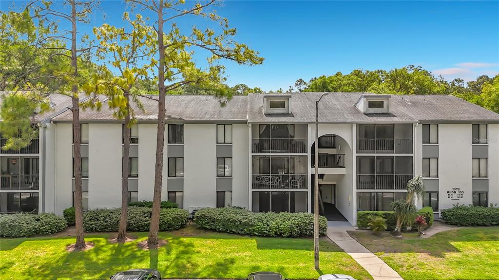 a front view of a house with swimming pool and glass windows