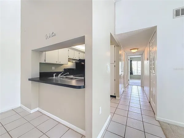 a kitchen with white cabinets and white appliances