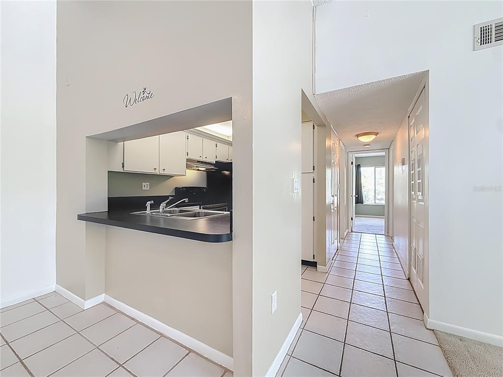 1372 Pine Ridge Circle East, Unit H3 Tarpon Springs, FL 34688 - Photo 12 of 53 a hallway with kitchen view and living room view