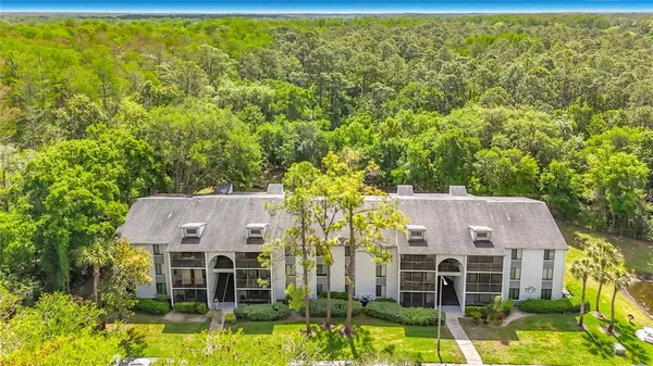 an aerial view of a house with swimming pool garden and patio