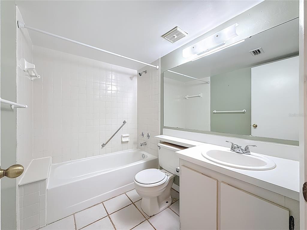 1372 Pine Ridge Circle East, Unit H3 Tarpon Springs, FL 34688 - Photo 23 of 53 a bathroom with a granite countertop sink a toilet and a bathtub
