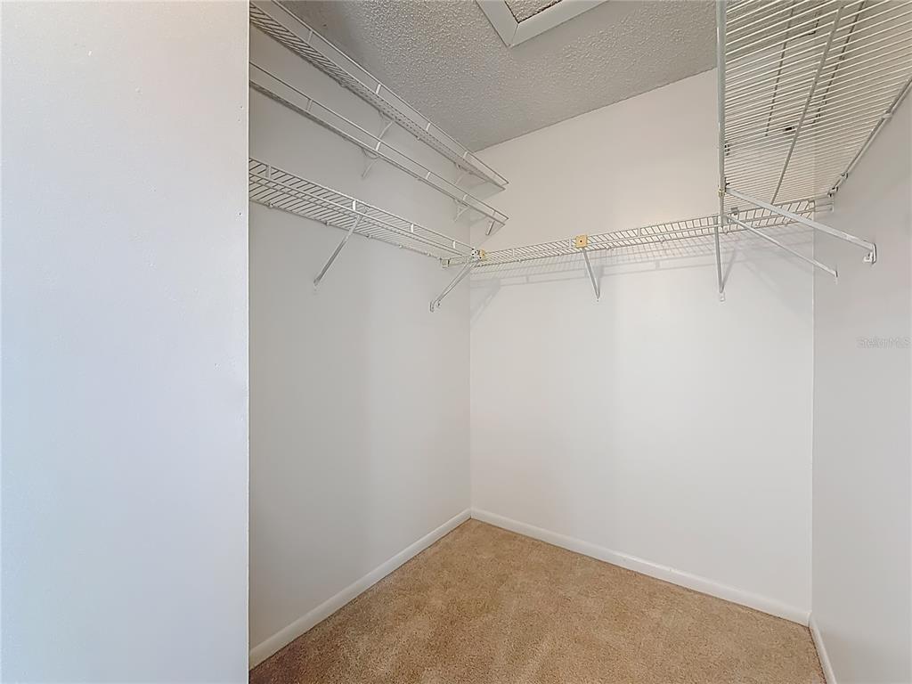 1372 Pine Ridge Circle East, Unit H3 Tarpon Springs, FL 34688 - Photo 28 of 53 a view of a room with racks on the wall