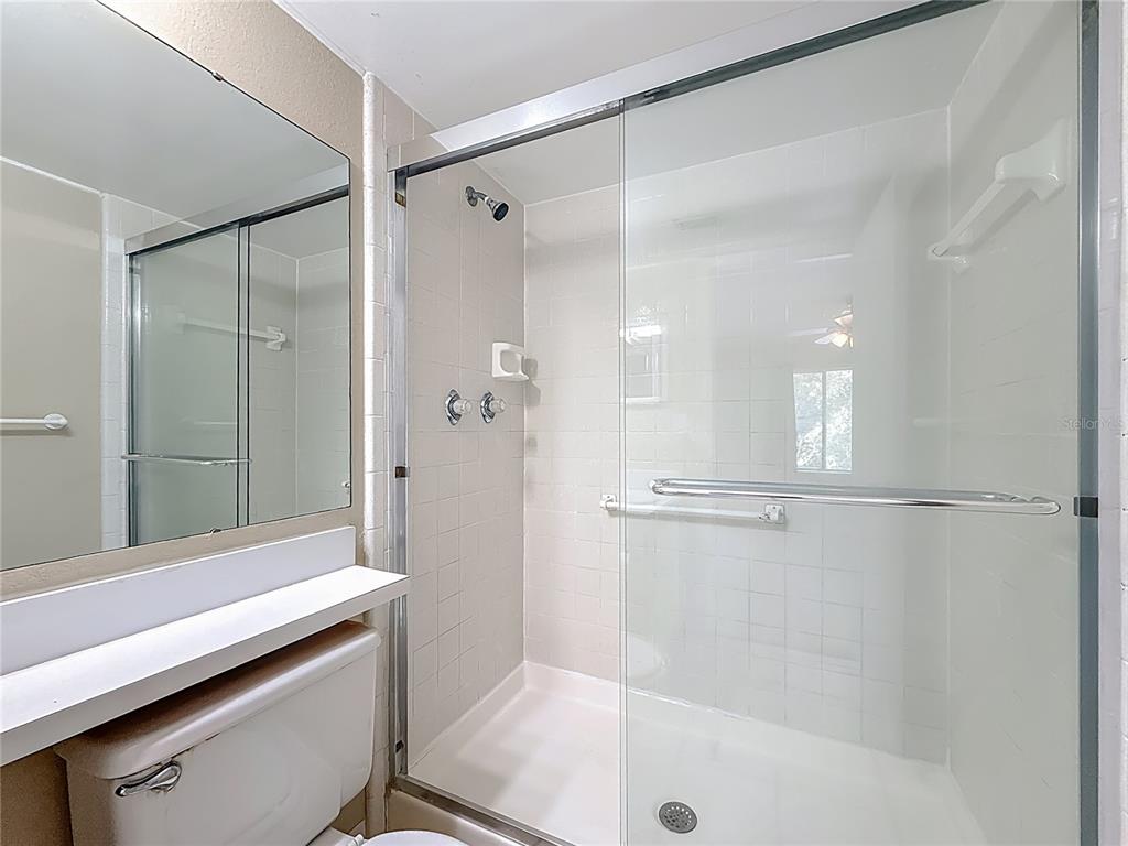 1372 Pine Ridge Circle East, Unit H3 Tarpon Springs, FL 34688 - Photo 31 of 53 a bathroom with a shower and a bath tub