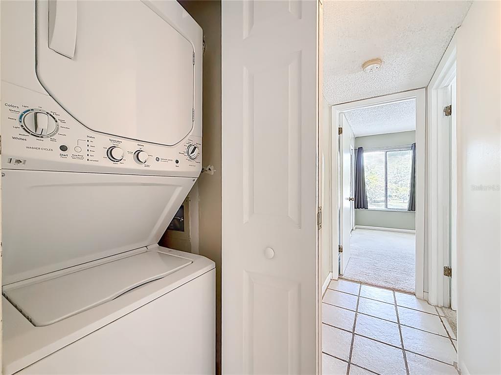 1372 Pine Ridge Circle East, Unit H3 Tarpon Springs, FL 34688 - Photo 32 of 53 a view of a hallway with washer and dryer