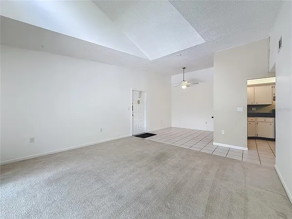 a hallway with kitchen view and living room view