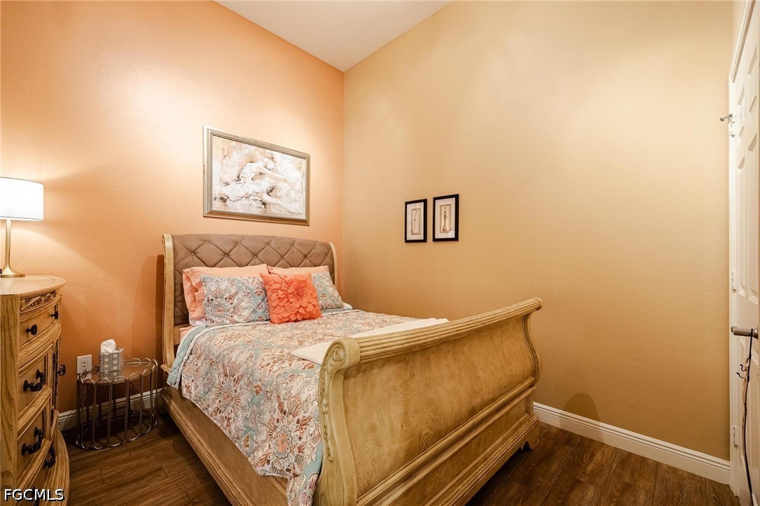 2745 First Street, Unit 306 Fort Myers, FL 33916 - Photo 11 of 50 a bedroom with a bed and wooden floor