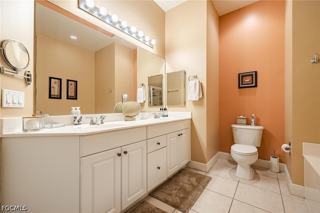 2745 First Street, Unit 306 Fort Myers, FL 33916 - Photo 12 of 50 a bathroom with a double vanity sink and a mirror