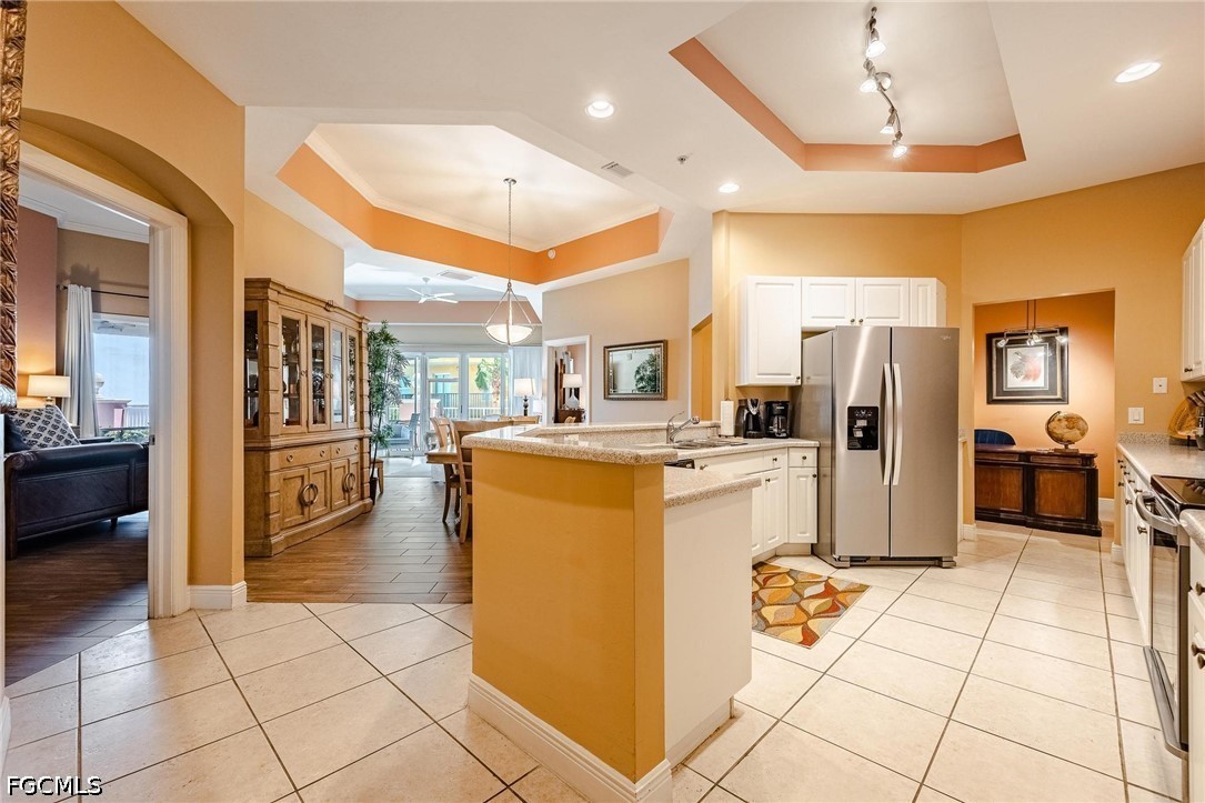 2745 First Street, Unit 306 Fort Myers, FL 33916 - Photo 21 of 50 a kitchen with stainless steel appliances kitchen island granite countertop a refrigerator and a stove