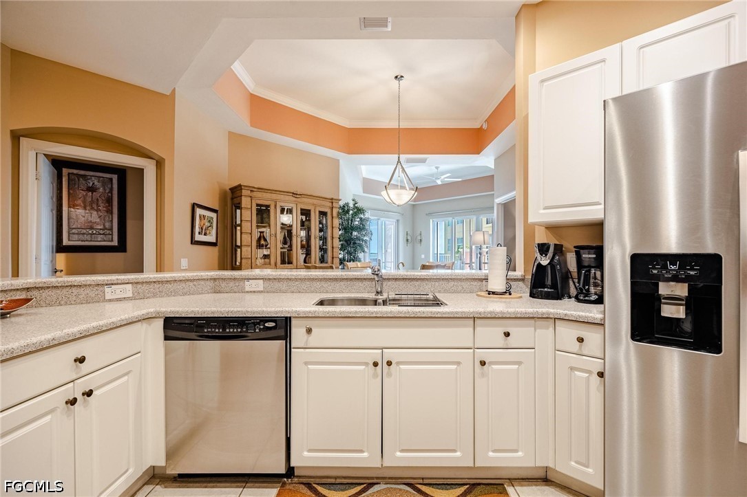 2745 First Street, Unit 306 Fort Myers, FL 33916 - Photo 4 of 50 a kitchen with stainless steel appliances granite countertop a refrigerator a sink dishwasher and white cabinets with wooden floor