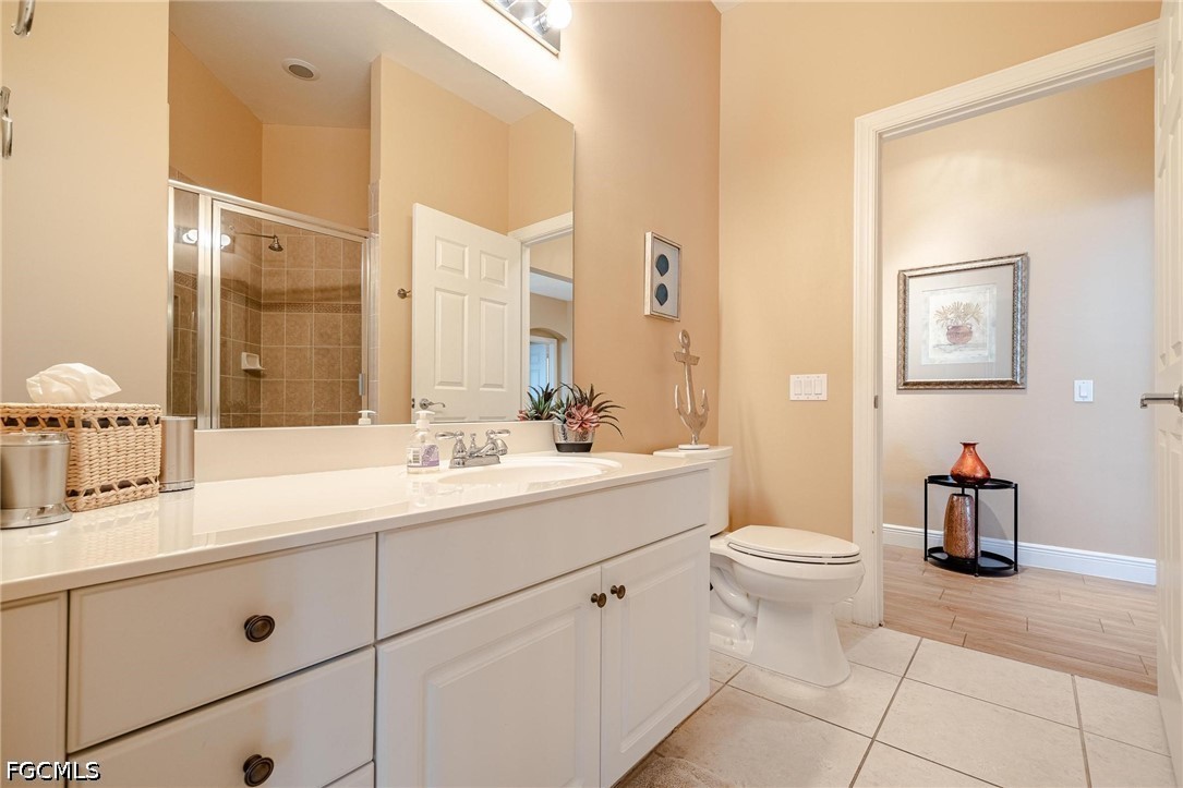 2745 First Street, Unit 306 Fort Myers, FL 33916 - Photo 8 of 50 a bathroom with a double vanity sink toilet and a mirror