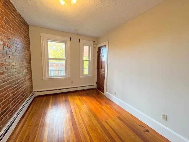 4 Mead Street, Unit 3 Boston, MA 02134 - Photo 13 of 20 a view of an empty room with wooden floor and a window