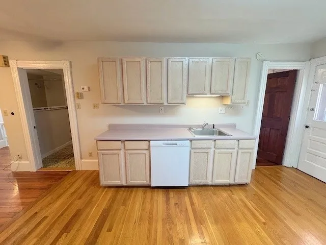 a kitchen with granite countertop a sink stove and cabinets
