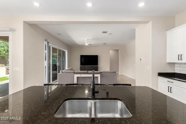 a kitchen with stainless steel appliances a sink stove and refrigerator