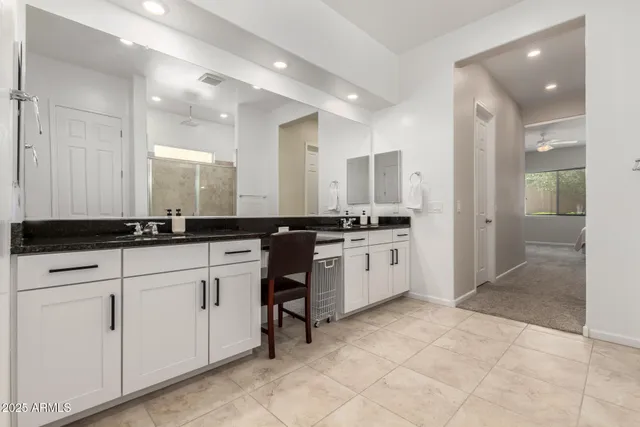 a view of kitchen with sink refrigerator and cabinets