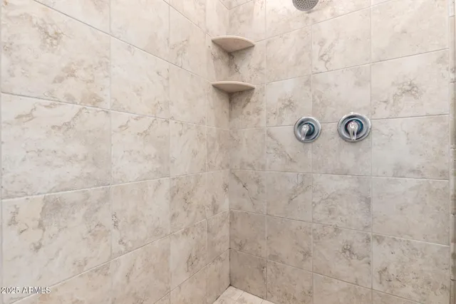 a kitchen with white cabinets and sink