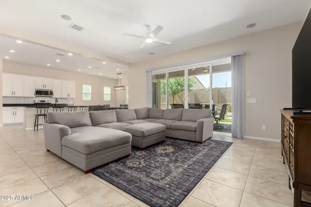 a view of hallway with a window and a refrigerator