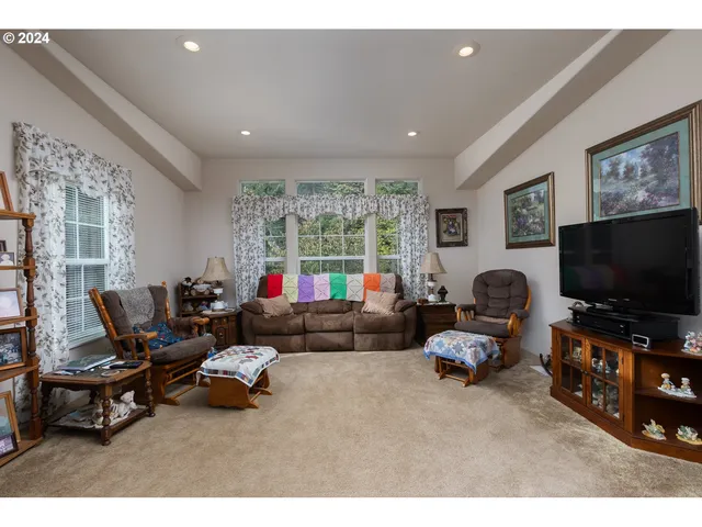 a dining room with kitchen island furniture a chandelier and kitchen view