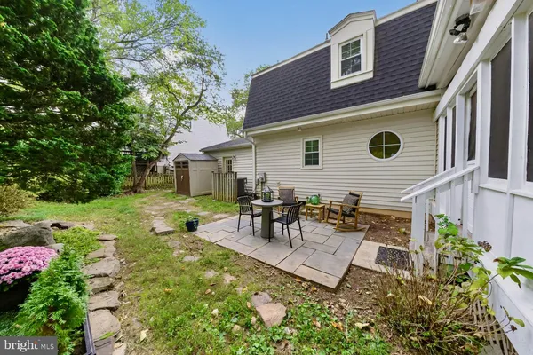 a view of a backyard with table and chairs and potted plants