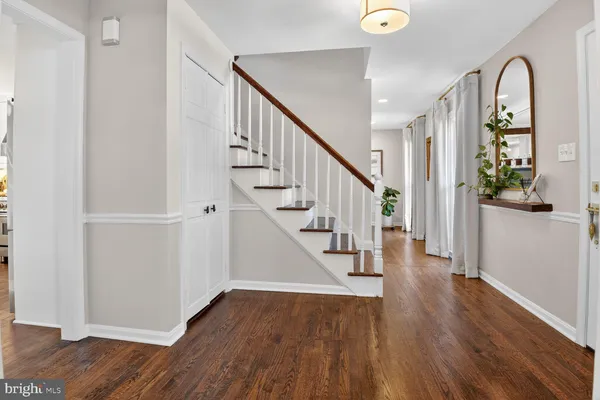 a view of entryway with wooden floor and stairs