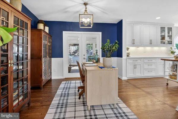 a living room with granite countertop furniture a fireplace and a chandelier