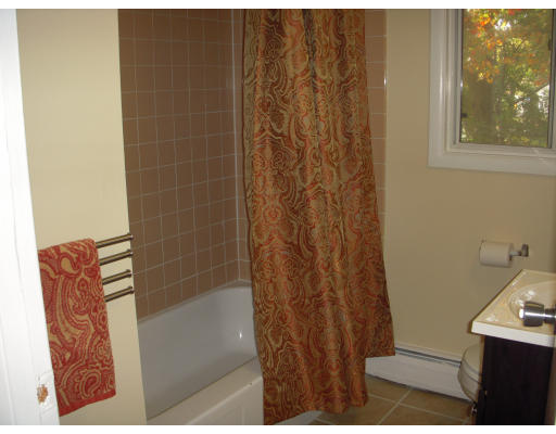 26 Manor Court, Unit 26 Springfield, MA 01118 - Photo 8 of 12 a bathroom with a shower curtain and a sink