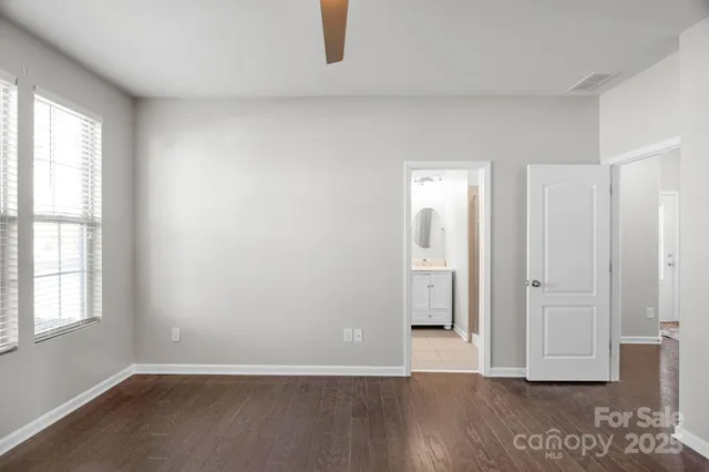 an empty room with wooden floor and a window