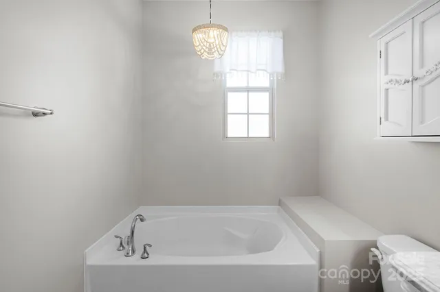 a white bath tub sitting next to a window