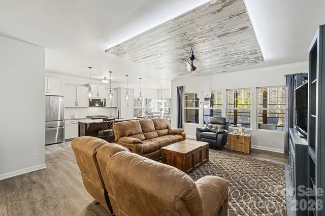 a view of a dining room with furniture and chandelier