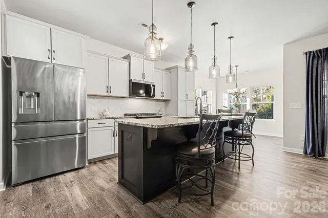a bathroom with a granite countertop sink a mirror and vanity