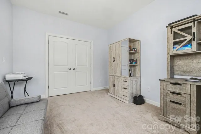 a view of kitchen space with refrigerator and window