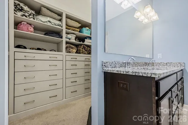 a bathroom with a shower a mirror and a shower