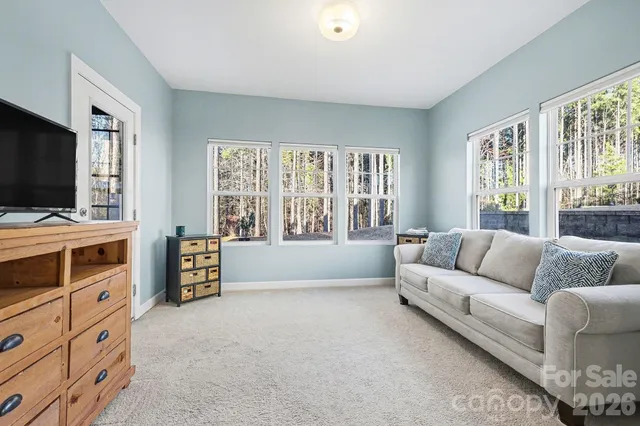 a view of an empty room with closet and a window