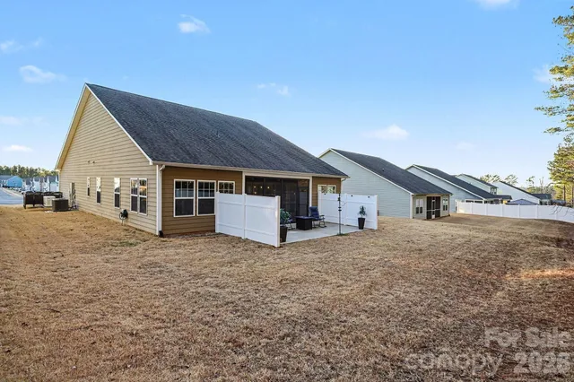 a view of a chairs and table in the backyard