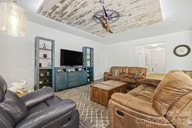 a living room with furniture and a chandelier