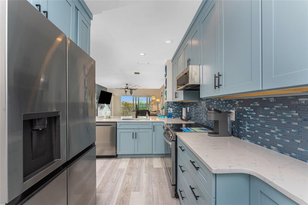 8405 Placida Road, Unit 406 Placida, FL 33946 - Photo 11 of 55 a kitchen with a sink stove and cabinets
