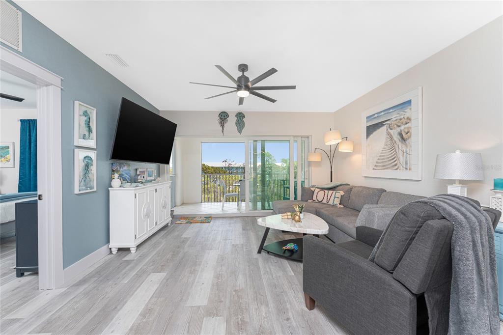 8405 Placida Road, Unit 406 Placida, FL 33946 - Photo 19 of 55 a living room with furniture and a flat screen tv