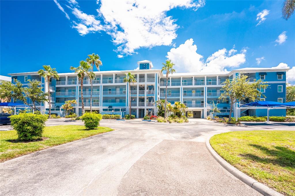 8405 Placida Road, Unit 406 Placida, FL 33946 - Photo 2 of 55 a view of a swimming pool with a patio and a fountain