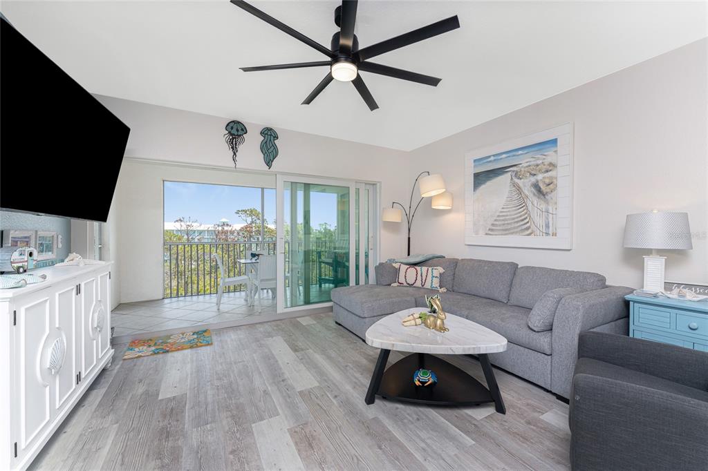8405 Placida Road, Unit 406 Placida, FL 33946 - Photo 21 of 55 a living room with furniture and a flat screen tv