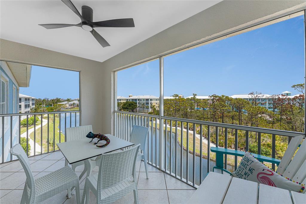 8405 Placida Road, Unit 406 Placida, FL 33946 - Photo 23 of 55 a view of a balcony dining area with a table & chairs