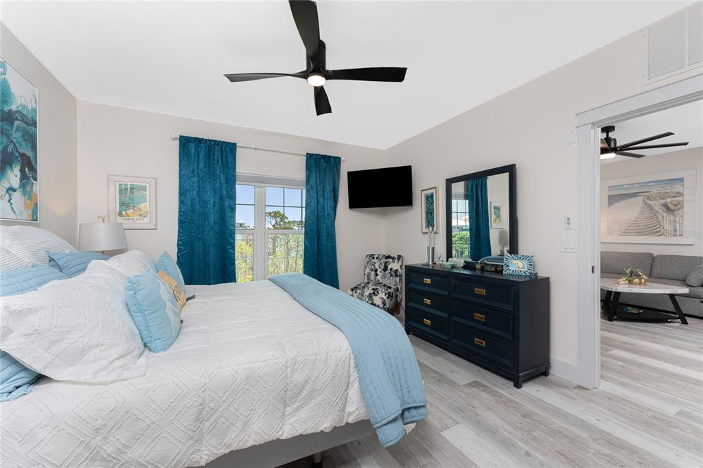 8405 Placida Road, Unit 406 Placida, FL 33946 - Photo 26 of 55 a spacious bedroom with a bed and a flat screen tv