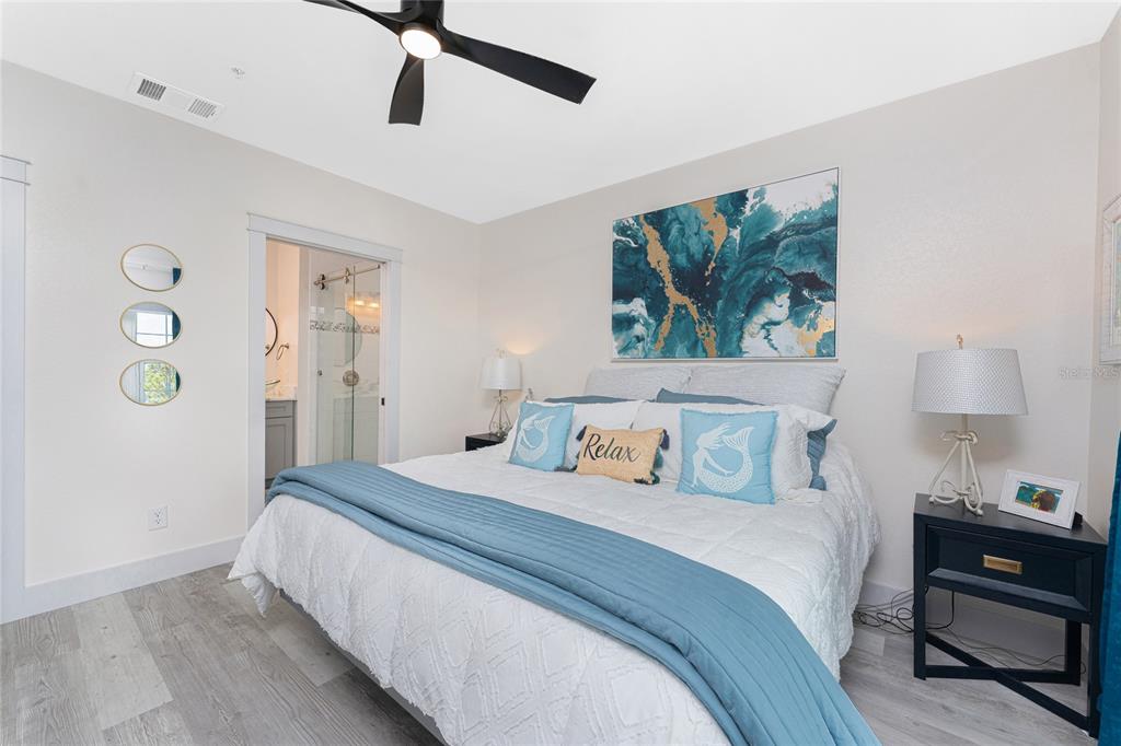 8405 Placida Road, Unit 406 Placida, FL 33946 - Photo 27 of 55 a bedroom with a bed and a lamp on the dresser