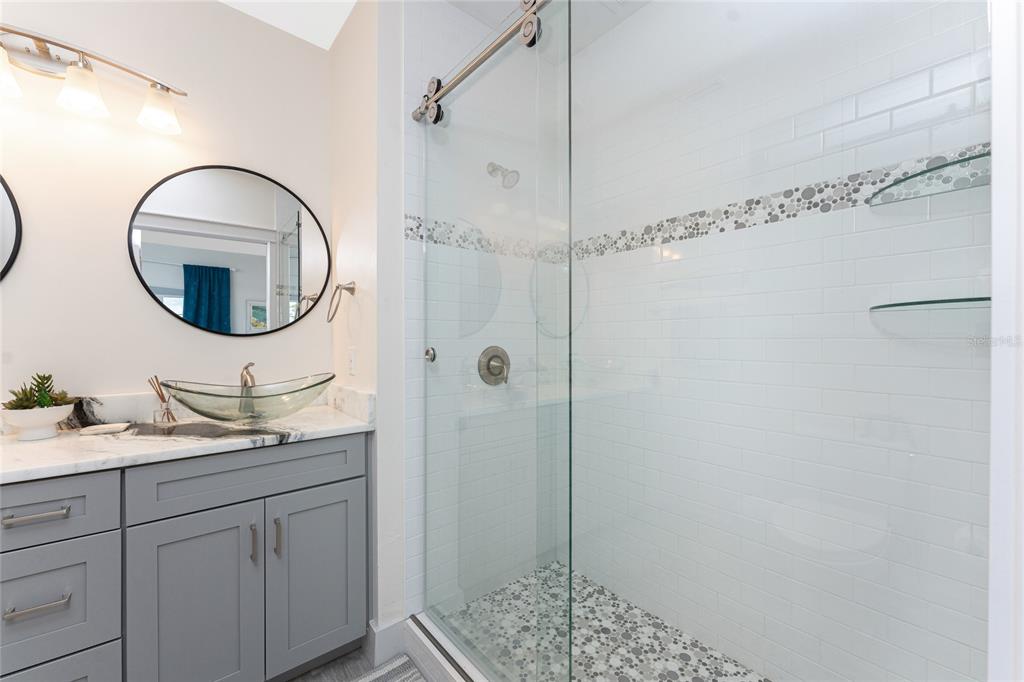 8405 Placida Road, Unit 406 Placida, FL 33946 - Photo 30 of 55 a bathroom with a sink and a mirror