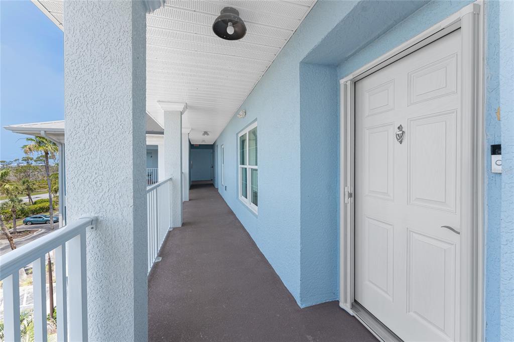 8405 Placida Road, Unit 406 Placida, FL 33946 - Photo 3 of 55 a view of a hallway with wooden floor and staircase